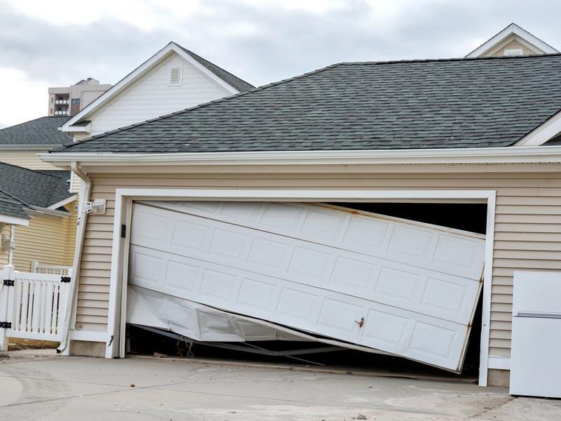 Off-track residential garage door hanging in the opening